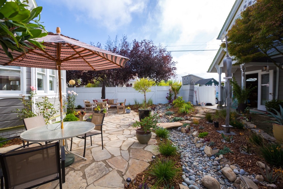 Design ideas for a mid-sized mediterranean backyard patio in San Luis Obispo with natural stone pavers and no cover.