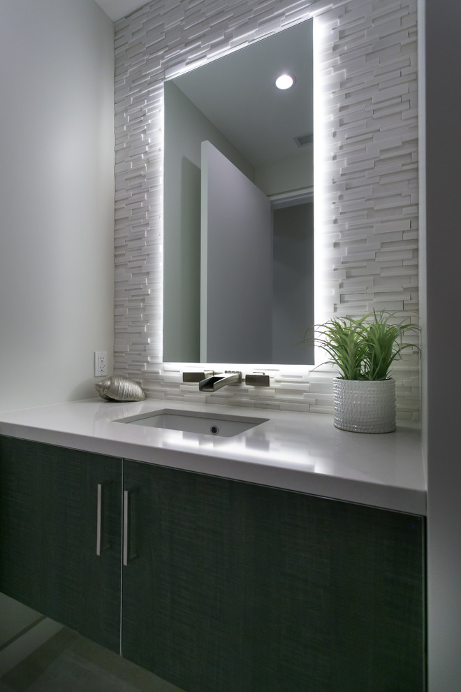 Mid-sized contemporary powder room in Los Angeles with flat-panel cabinets, dark wood cabinets, white tile, porcelain tile, white walls, porcelain floors, an undermount sink and engineered quartz benchtops.