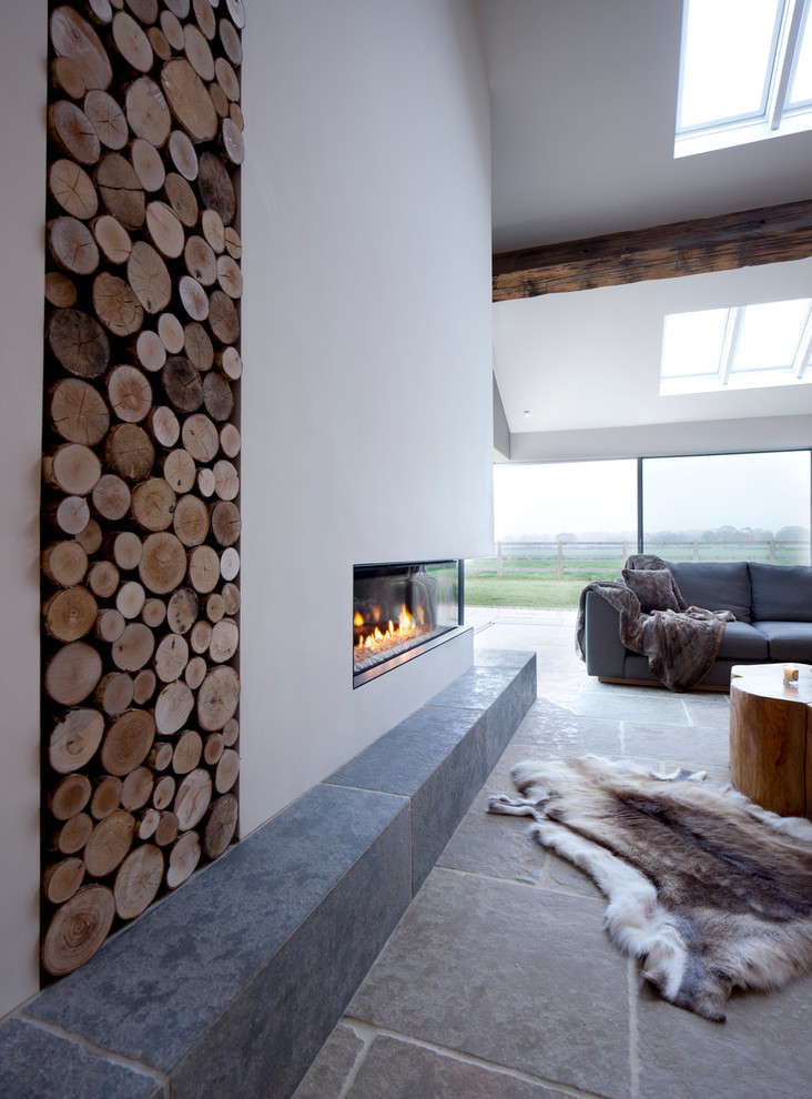 Inspiration for a contemporary open concept living room in Manchester with white walls and a ribbon fireplace.