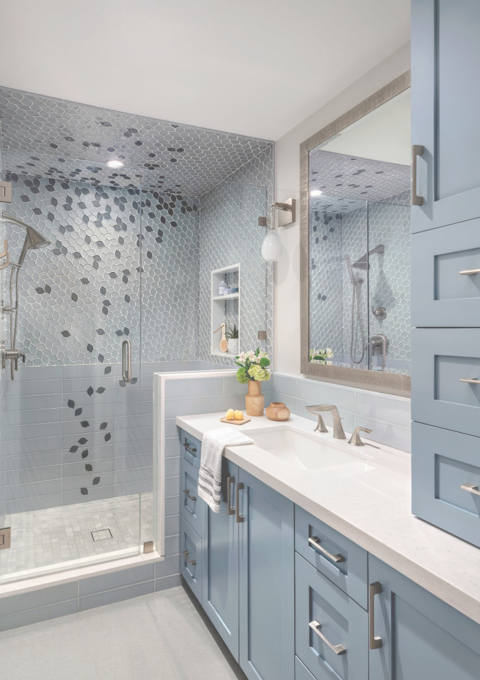 Mid-sized transitional master gray tile and ceramic tile porcelain tile, gray floor and single-sink bathroom photo in Phoenix with shaker cabinets, blue cabinets, a one-piece toilet, white walls, an undermount sink, quartz countertops, a hinged shower door, white countertops and a built-in vanity