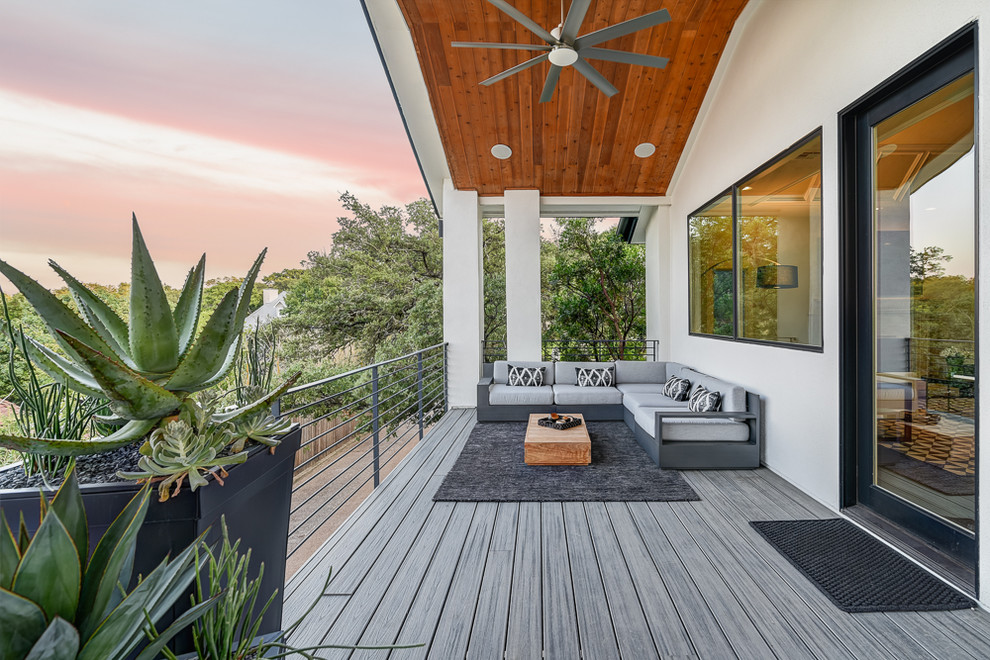 Design ideas for a contemporary backyard deck in Austin with a roof extension.