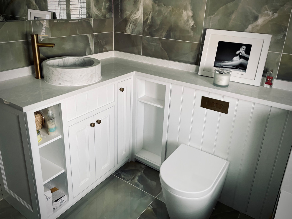 This is an example of a small traditional master bathroom in Cardiff with beaded inset cabinets, white cabinets, a drop-in tub, a shower/bathtub combo, a wall-mount toilet, green tile, ceramic tile, ceramic floors, a trough sink, quartzite benchtops, green floor, white benchtops, an enclosed toilet, a single vanity and a built-in vanity.