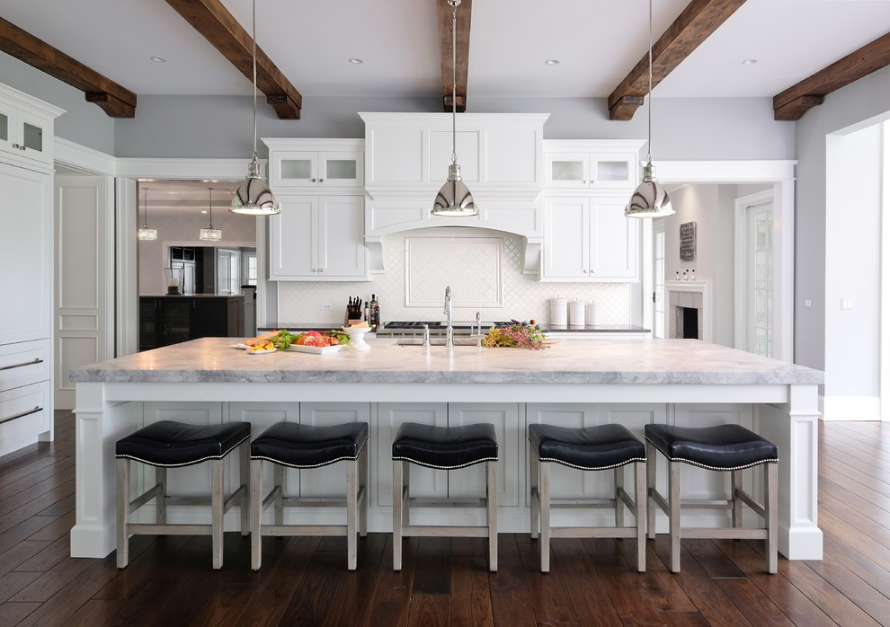 Inspiration for a large transitional l-shaped dark wood floor eat-in kitchen remodel in Chicago with white cabinets, paneled appliances, an island, an undermount sink, beaded inset cabinets, quartzite countertops, white backsplash and porcelain backsplash