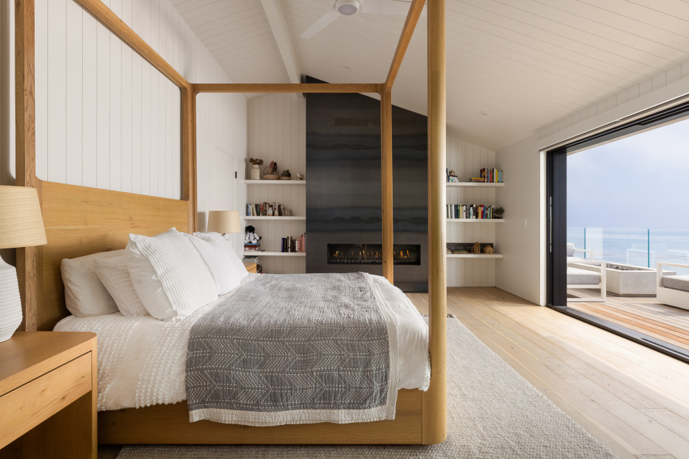 Trendy light wood floor, beige floor, shiplap ceiling, vaulted ceiling and shiplap wall bedroom photo in San Luis Obispo with white walls, a ribbon fireplace and a stone fireplace