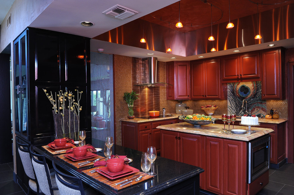 Eclectic l-shaped eat-in kitchen in New Orleans with raised-panel cabinets, black cabinets, marble benchtops, metallic splashback, glass tile splashback and multiple islands.