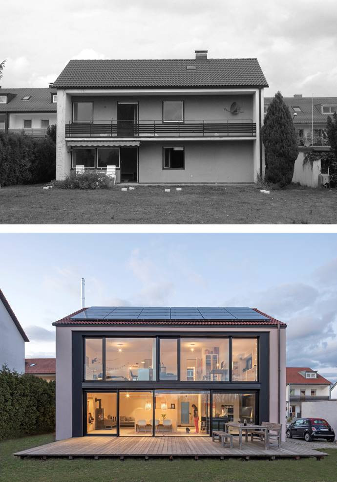 Inspiration for a mid-sized industrial two-storey stucco house exterior in Munich with a gable roof and a tile roof.
