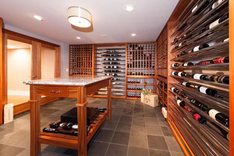 Photo of a mid-sized traditional wine cellar in New York with display racks and grey floor.