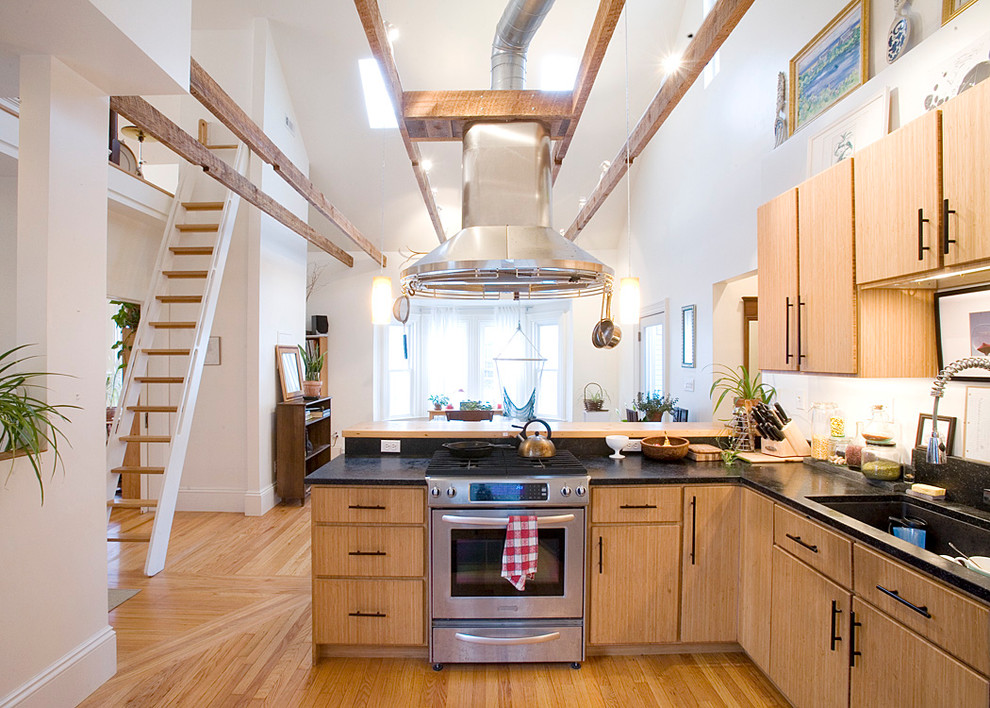 Large country u-shaped eat-in kitchen in Boston with an undermount sink, flat-panel cabinets, stainless steel appliances, light hardwood floors, medium wood cabinets, wood benchtops and with island.