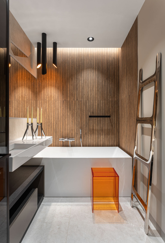 Photo of a contemporary master bathroom in Moscow with an alcove tub, brown tile, a wall-mount sink, grey floor, a single vanity and a freestanding vanity.