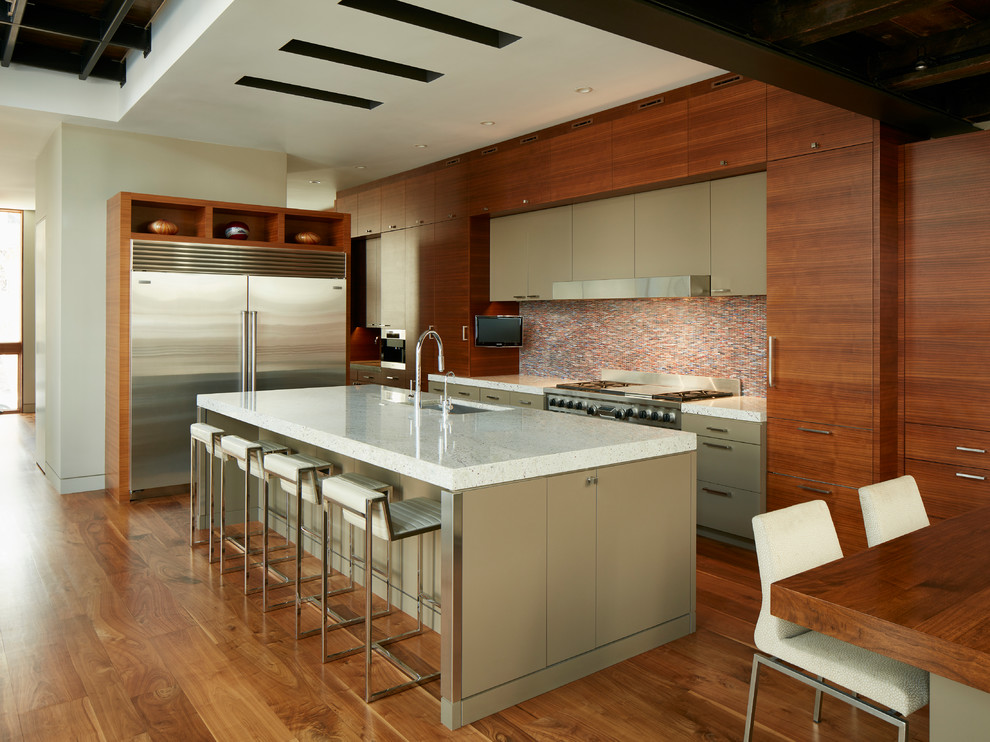 Inspiration for a contemporary eat-in kitchen in Chicago with an undermount sink, flat-panel cabinets, medium wood cabinets, multi-coloured splashback, mosaic tile splashback, stainless steel appliances, medium hardwood floors and with island.