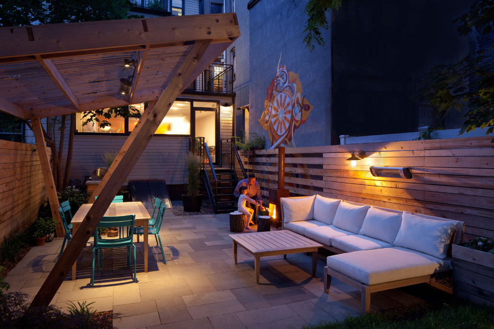 Design ideas for a small modern backyard patio in New York with a fire feature and natural stone pavers.