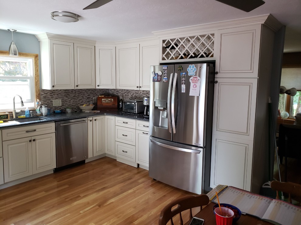 Mid-sized u-shaped eat-in kitchen in Other with white cabinets, no island and blue benchtop.