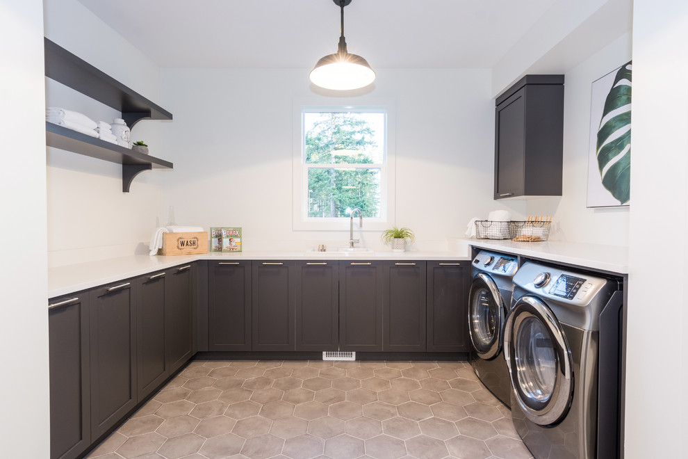 Inspiration for a large country u-shaped dedicated laundry room in Vancouver with a drop-in sink, shaker cabinets, brown cabinets, quartz benchtops, white walls, a side-by-side washer and dryer and white benchtop.