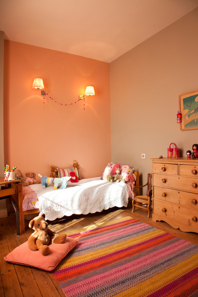 Large transitional kids' bedroom in Marseille with medium hardwood floors and multi-coloured walls for kids 4-10 years old and girls.
