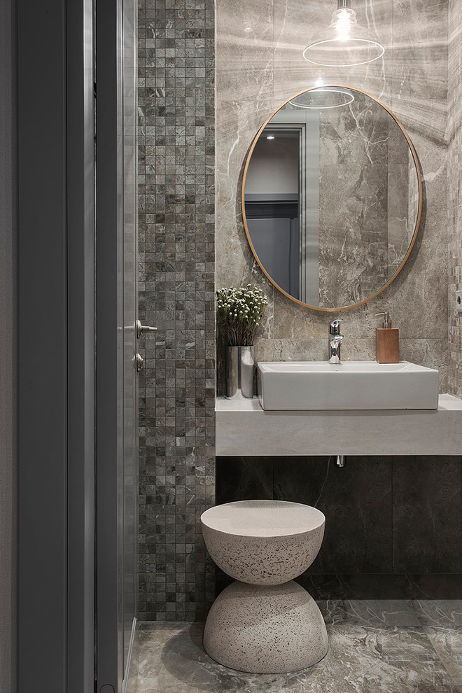 Inspiration for a contemporary powder room in Moscow with porcelain tile, porcelain floors, a vessel sink, gray tile and grey floor.