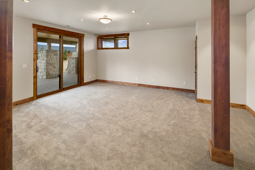Example of a mountain style walk-out carpeted and beige floor basement design in Seattle with white walls