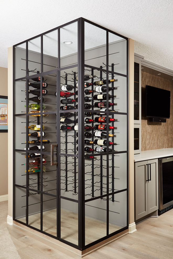 Inspiration for a mid-sized transitional wine cellar in Minneapolis with light hardwood floors, storage racks and beige floor.