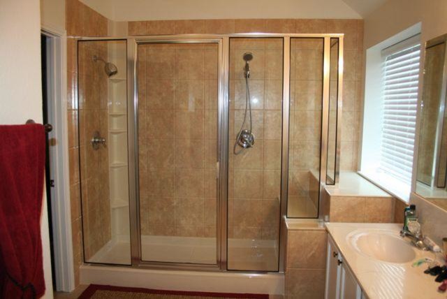 Inspiration for a medium sized contemporary ensuite bathroom with a corner shower and brown tiles.