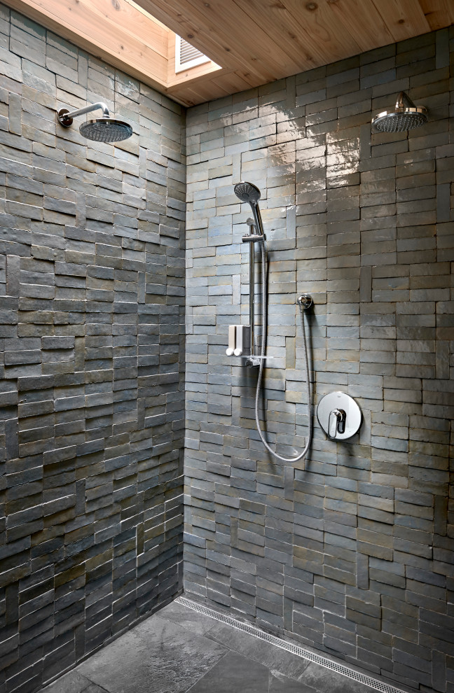 Lawless Retreat - A carefully positioned skylight pulls sunlight down into the shower. The reflectance off of the glazed handmade tiles suggests water pouring down the stone walls of a cave.