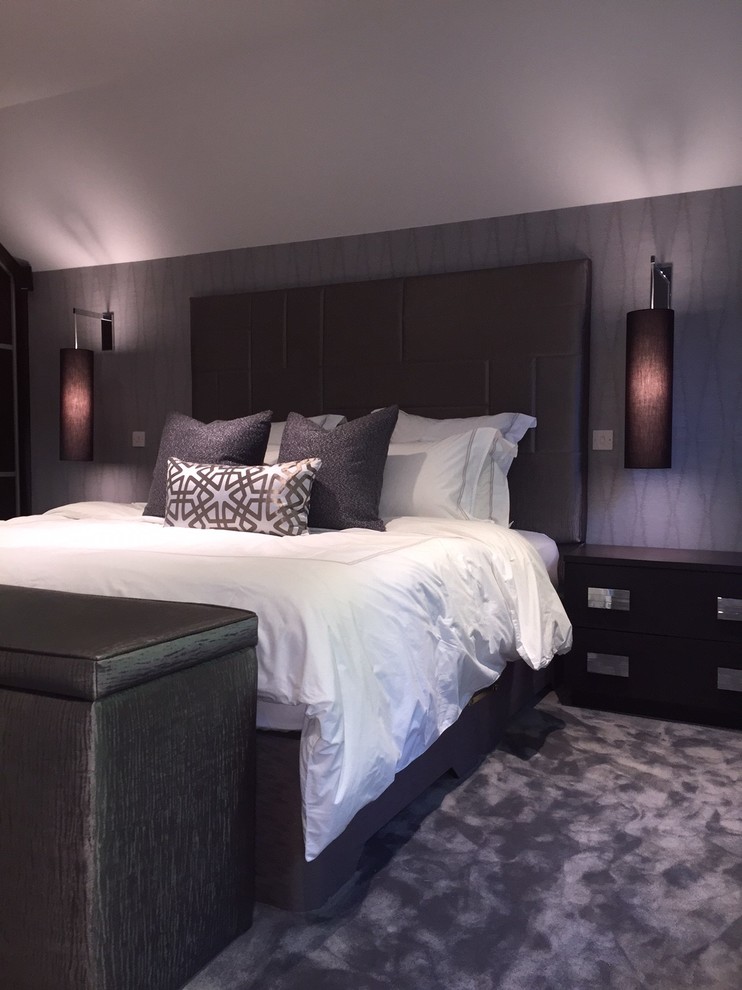 Design ideas for a mid-sized contemporary master bedroom in West Midlands with grey walls and carpet.