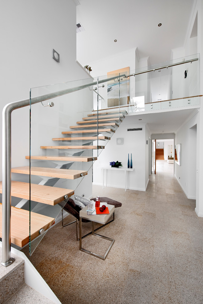 This is an example of a contemporary wood l-shaped staircase in Perth with open risers and glass railing.
