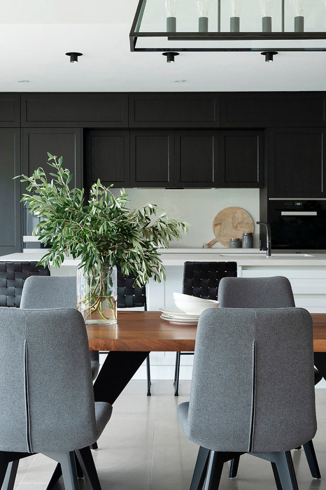 Design ideas for a traditional galley kitchen in Perth with a double-bowl sink, shaker cabinets, black appliances, with island and white benchtop.