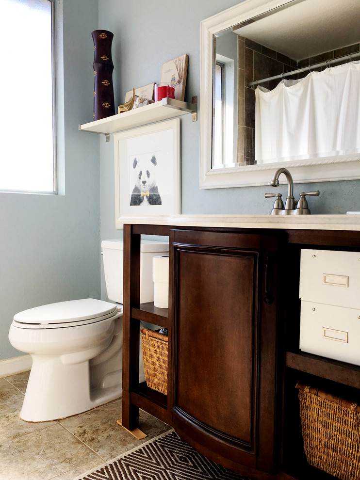 Small eclectic kids bathroom in Los Angeles with a two-piece toilet and blue walls.