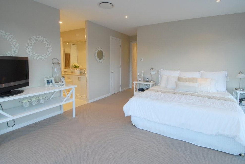 This is an example of a large traditional master bedroom in Brisbane with grey walls, carpet and grey floor.