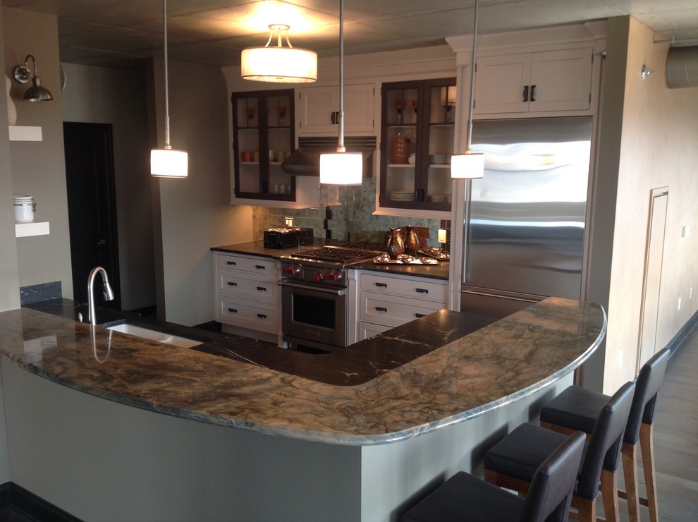 Example of a large transitional galley medium tone wood floor eat-in kitchen design in Milwaukee with white cabinets, granite countertops, gray backsplash, stainless steel appliances, a peninsula, a double-bowl sink, recessed-panel cabinets and mirror backsplash
