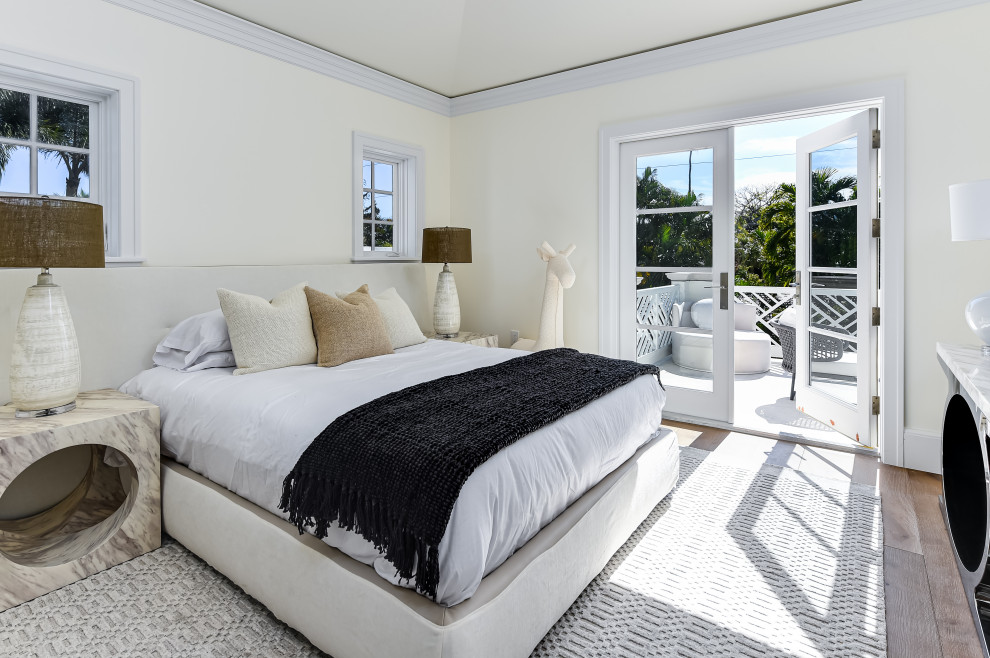 This is an example of an expansive transitional guest bedroom in Miami with white walls, dark hardwood floors, brown floor and coffered.