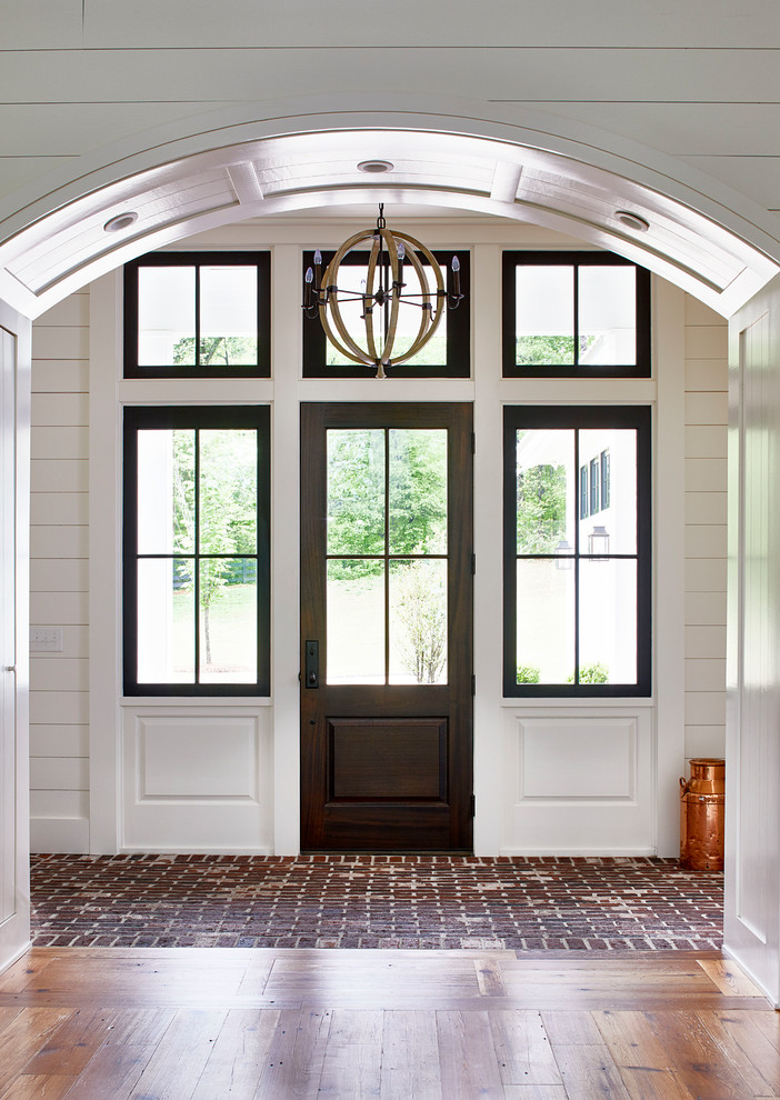 Design ideas for a mid-sized country front door in Atlanta with white walls, brick floors, a single front door, a glass front door and red floor.