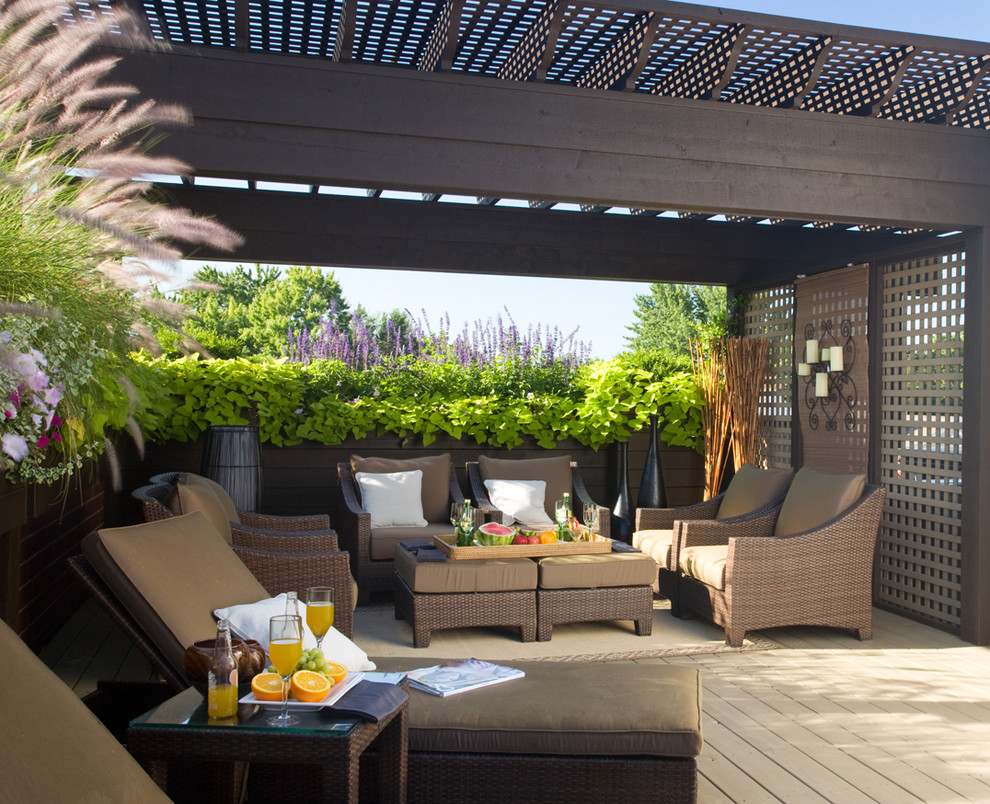 Large transitional rooftop deck in Chicago with a pergola.