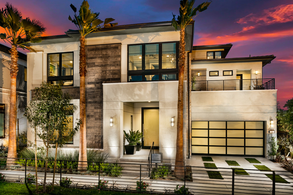 Design ideas for a large contemporary three-storey stucco house exterior in Orange County with a tile roof.