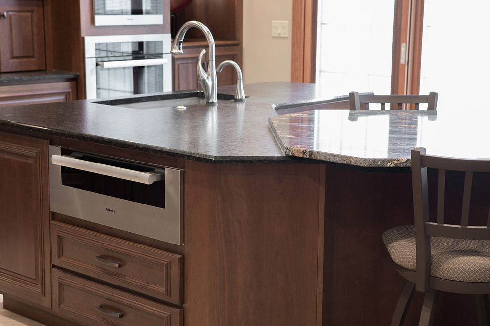Inspiration for a large transitional kitchen remodel with an undermount sink, raised-panel cabinets, stainless steel appliances and an island