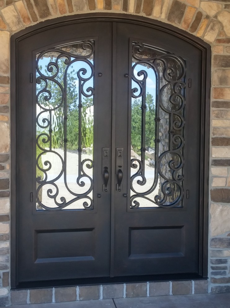 This is an example of a mid-sized traditional front door in Denver with beige walls, concrete floors, a double front door, a metal front door and grey floor.