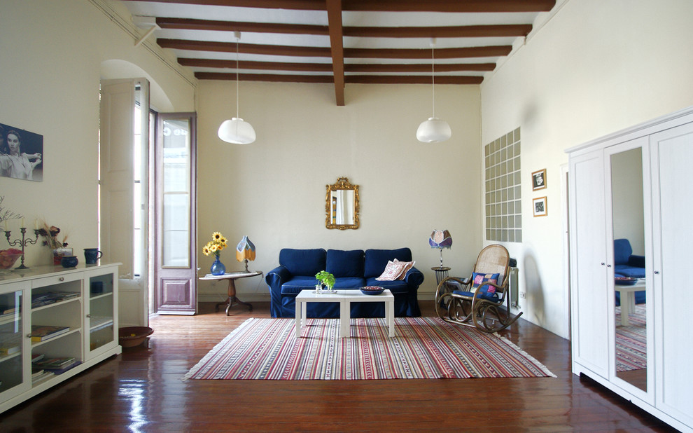 Design ideas for a large transitional enclosed family room in Barcelona with yellow walls, dark hardwood floors, no fireplace and no tv.