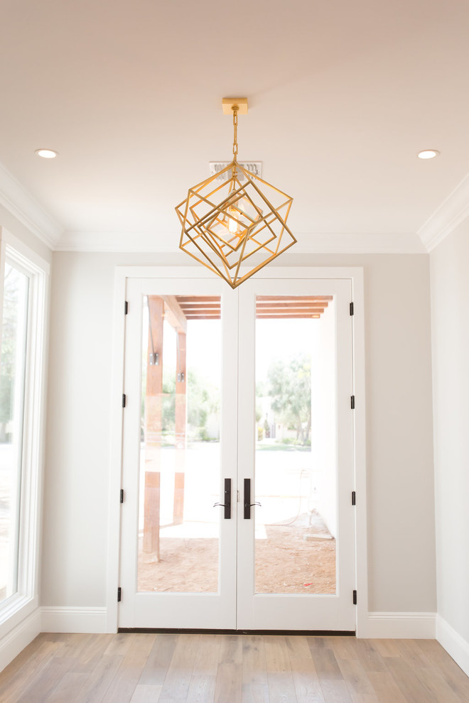 This is an example of a large transitional foyer in Phoenix with grey walls, a double front door, a white front door, medium hardwood floors and grey floor.