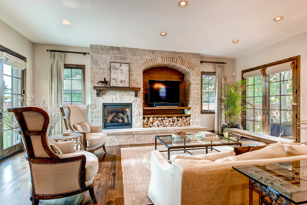 Inspiration for a large transitional formal open concept living room in Denver with white walls, dark hardwood floors, a standard fireplace, a stone fireplace surround and a built-in media wall.