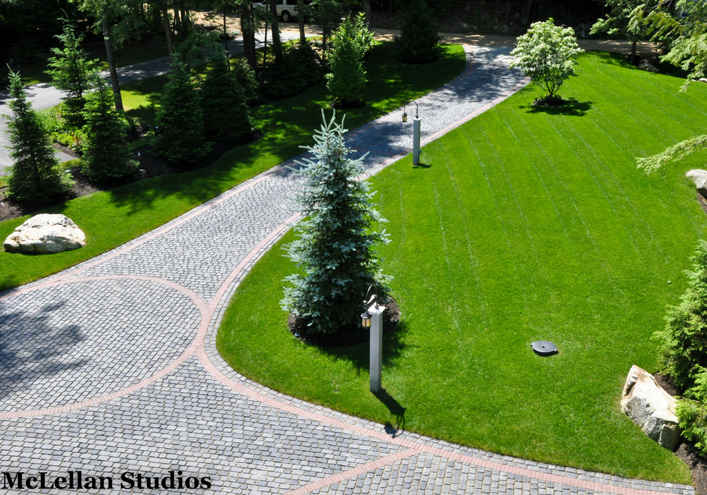 Inspiration for a traditional front yard driveway in Manchester with concrete pavers.