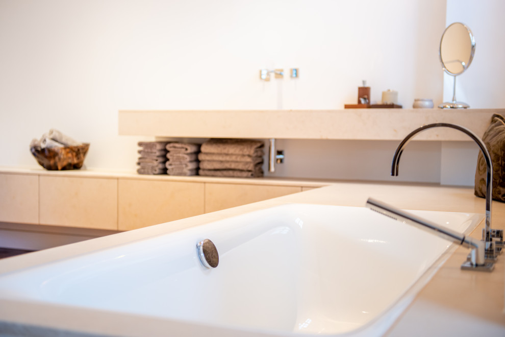 Photo of a large contemporary ensuite bathroom in Stuttgart with a built-in bath, a built-in shower, medium hardwood flooring, a submerged sink, limestone worktops, brown floors, an open shower, beige worktops, a single sink and a floating vanity unit.