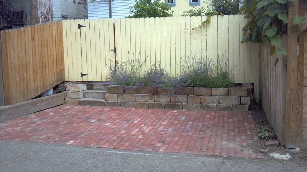 Inspiration for a small traditional backyard full sun driveway for summer in Other with a garden path and brick pavers.