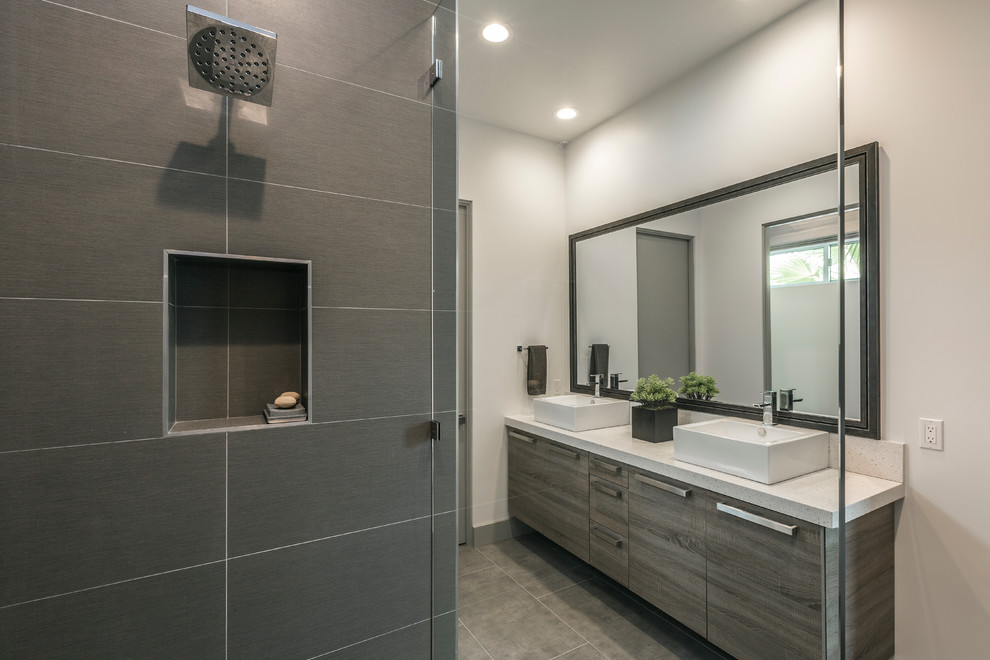 Design ideas for a large contemporary master bathroom in Los Angeles with flat-panel cabinets, dark wood cabinets, an alcove shower, gray tile, subway tile, white walls, porcelain floors, a vessel sink and engineered quartz benchtops.