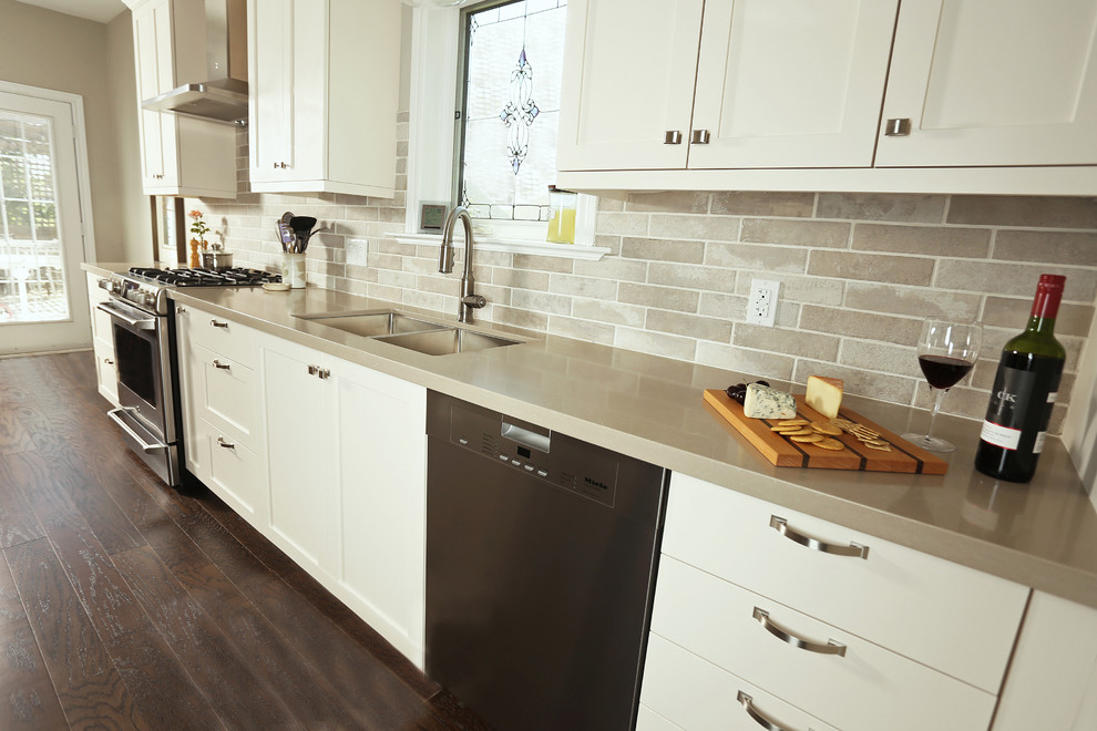 Inspiration for a mid-sized transitional galley dark wood floor and brown floor open concept kitchen remodel with an undermount sink, shaker cabinets, beige cabinets, quartz countertops, beige backsplash, porcelain backsplash, stainless steel appliances and no island