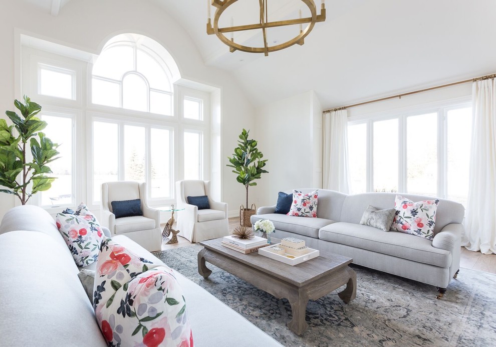 Inspiration for a large transitional formal and enclosed light wood floor and brown floor living room remodel in Toronto with white walls, a standard fireplace, a stone fireplace and no tv