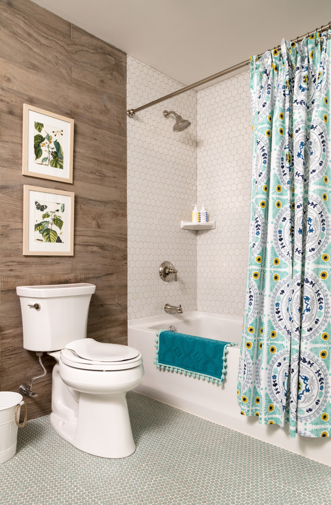 Photo of a small eclectic bathroom in Boston with a drop-in tub, a shower/bathtub combo, brown tile, ceramic tile, ceramic floors, a trough sink, blue floor and a shower curtain.