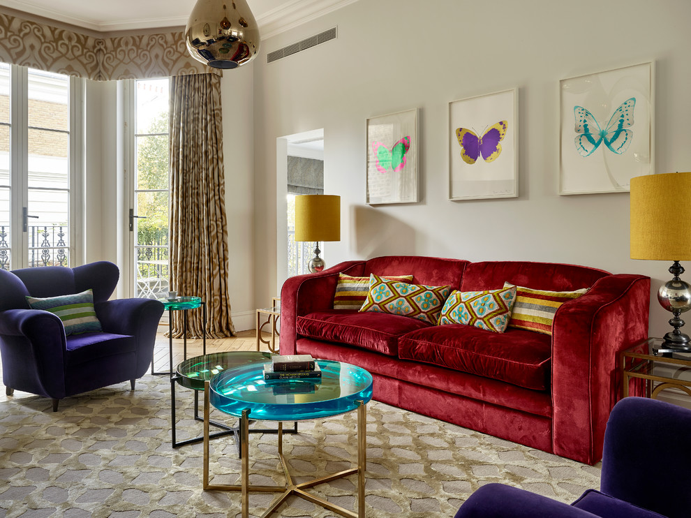 This is an example of an eclectic living room in London with beige walls and carpet.
