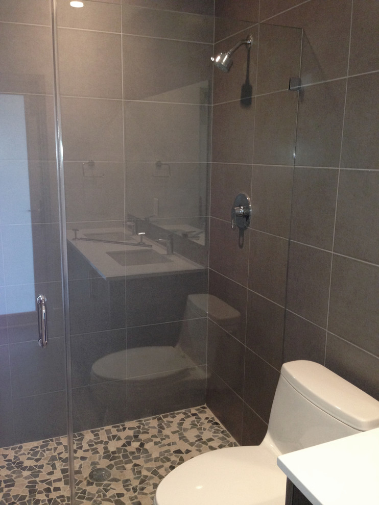 Inspiration for a mid-sized transitional 3/4 gray tile corner shower remodel in Miami with a one-piece toilet and gray walls