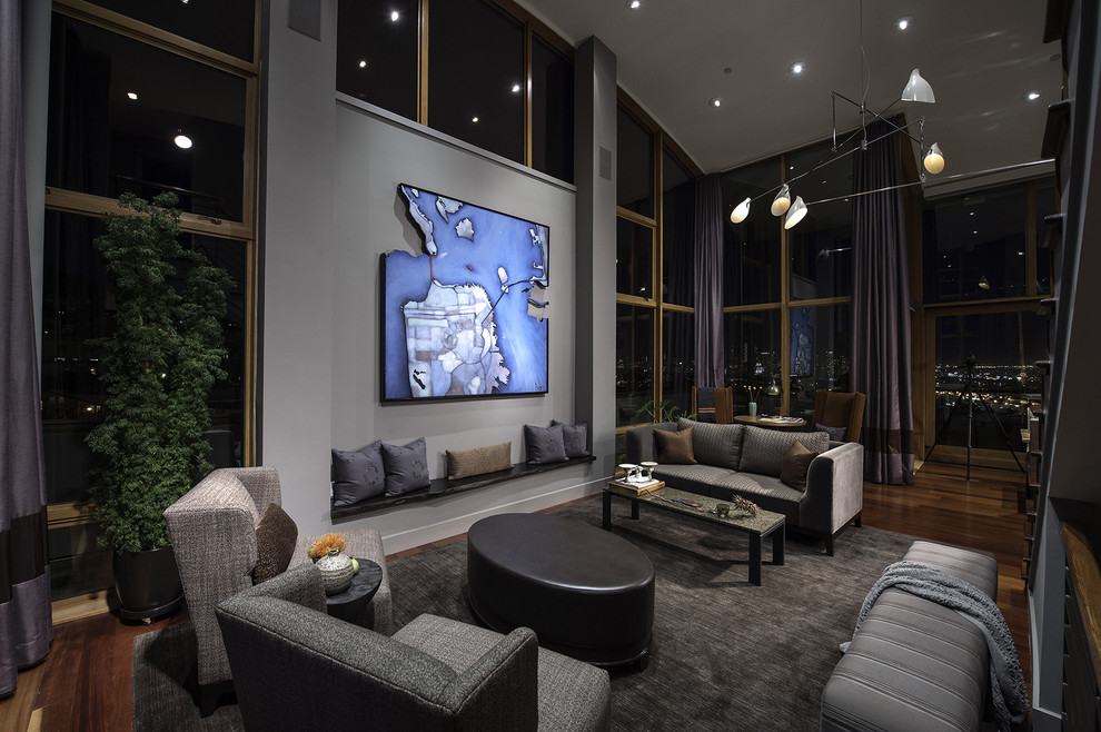 This is an example of a large contemporary open concept living room in San Francisco with grey walls, dark hardwood floors, no fireplace and brown floor.