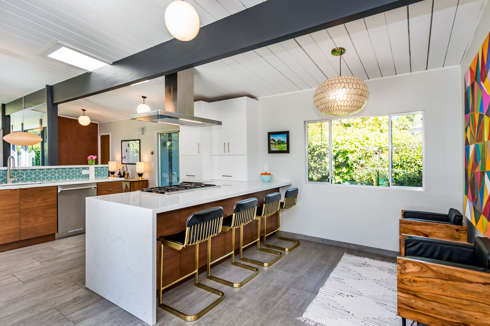 Design ideas for a mid-sized midcentury single-wall open plan kitchen in San Francisco with a drop-in sink, flat-panel cabinets, white cabinets, quartzite benchtops, blue splashback, ceramic splashback, stainless steel appliances, painted wood floors, a peninsula, grey floor and white benchtop.