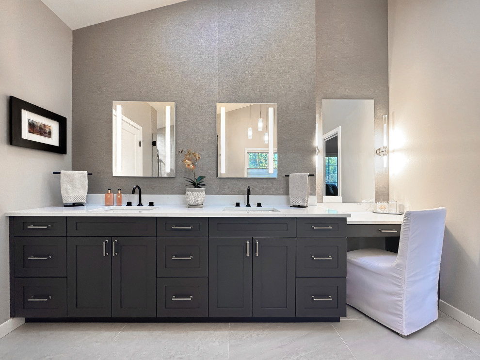 Inspiration for a large transitional master beige tile and porcelain tile porcelain tile, beige floor, double-sink and vaulted ceiling freestanding bathtub remodel in Seattle with shaker cabinets, gray cabinets, beige walls, an undermount sink, quartz countertops, a hinged shower door, white countertops and a built-in vanity